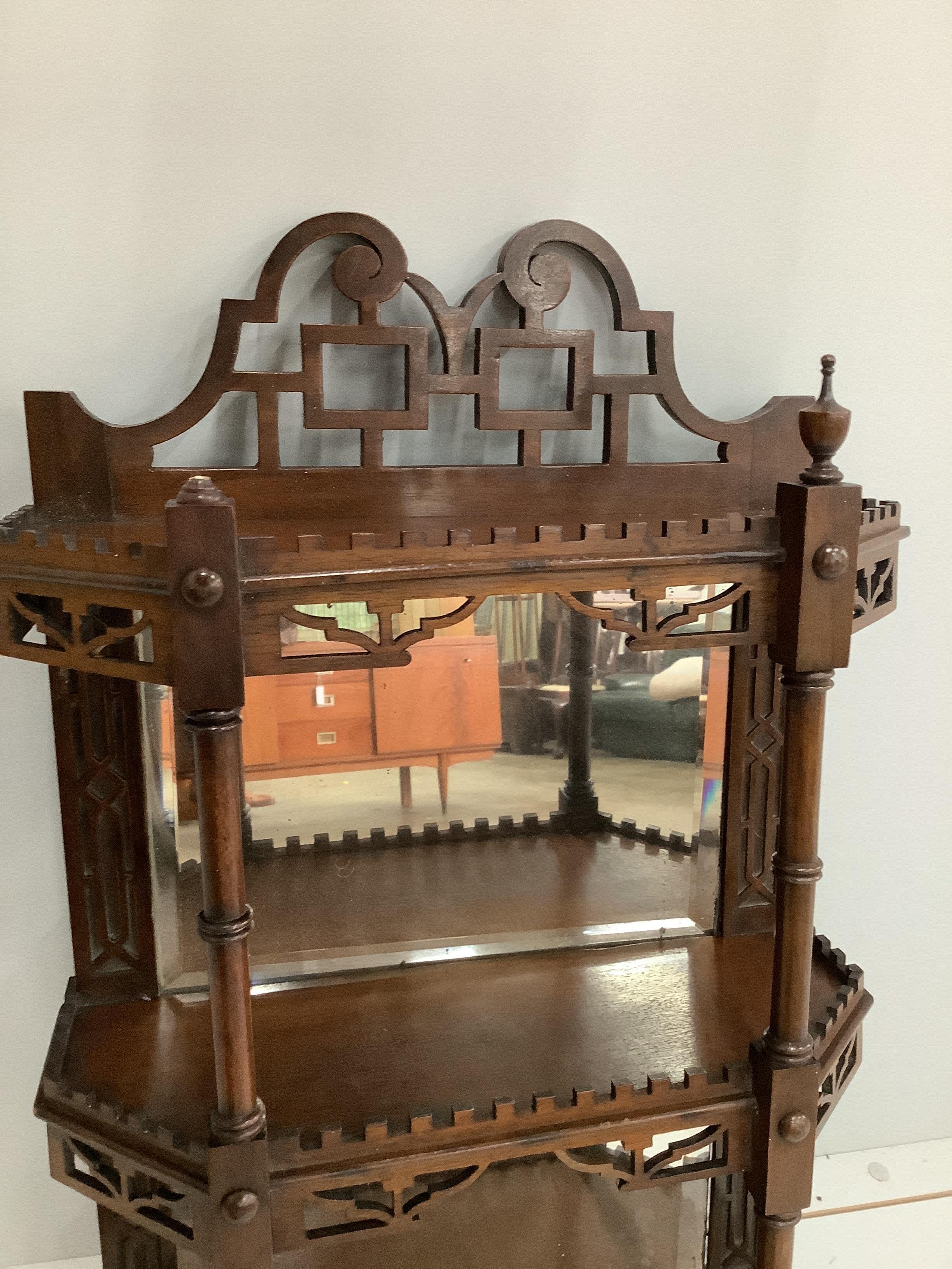 A late Victorian mahogany three tier mirrored wall bracket, width 40cm, height 76cm